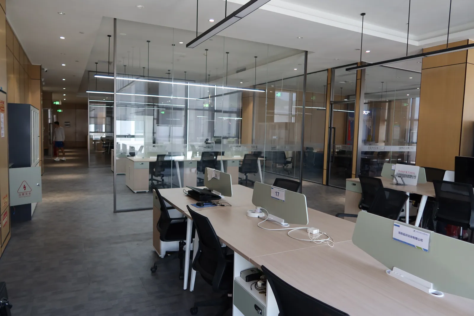 Open desks and private glass rooms in the workspace area