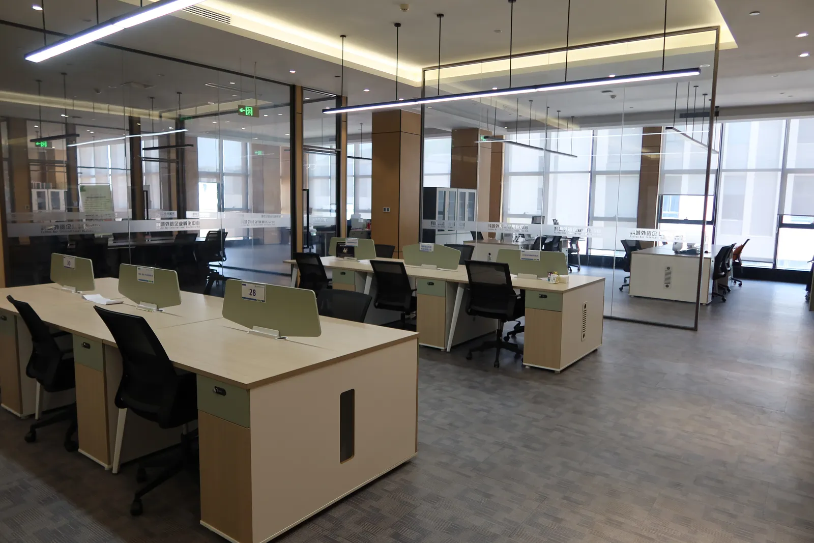 Glass office area with individual desks inside the business hub